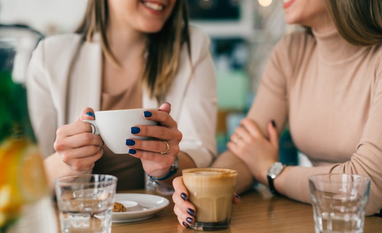 Close,Up,Of,Woman,Holding,Cup,Of,Coffee,In,Cafeteria