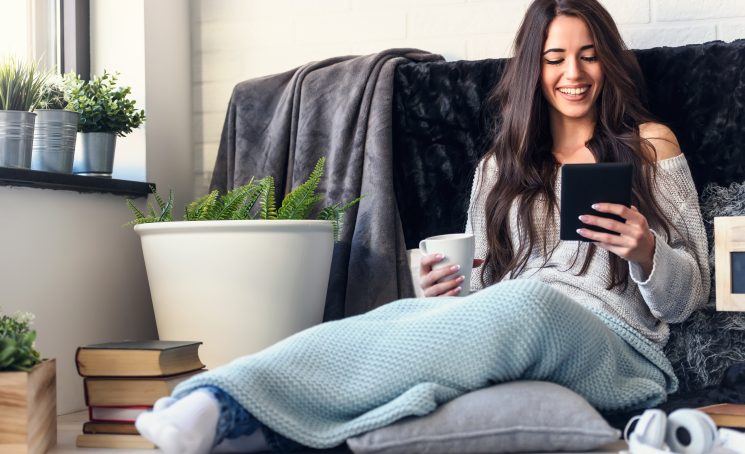 Beautiful,Young,Woman,Reading,E,Book,Reader,At,Home,Surrounded