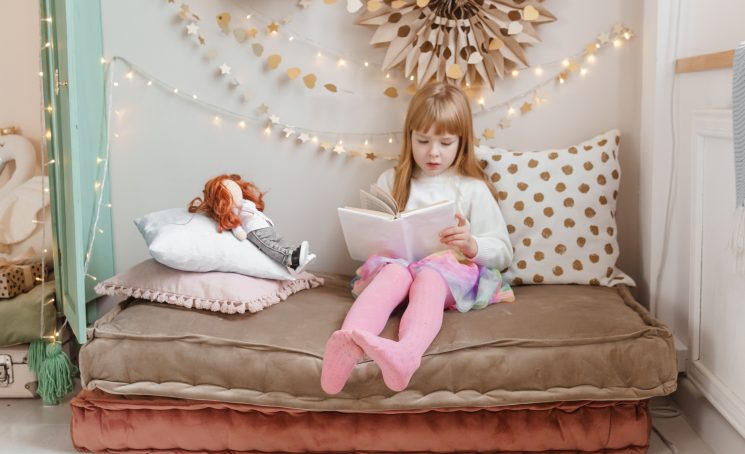 A,Little,Red-haired,Girl,Is,Reading,A,Book,To,Her