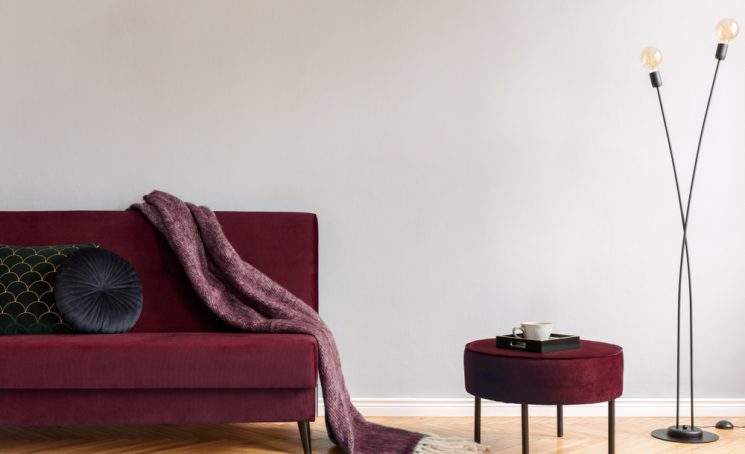 Minimalistic,Home,Interior,With,Burgundy,Velvet,Design,Sofa,And,Pouf,